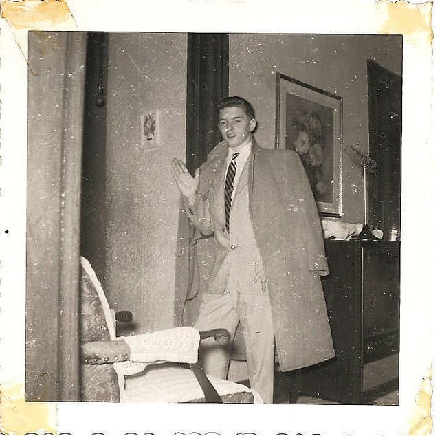A man in a suit, symbolizing the World Needs Adults, stands confidently in front of a door.