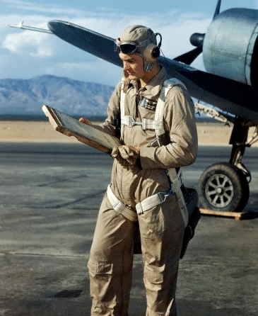 The man is checking a map in front of the airplane.