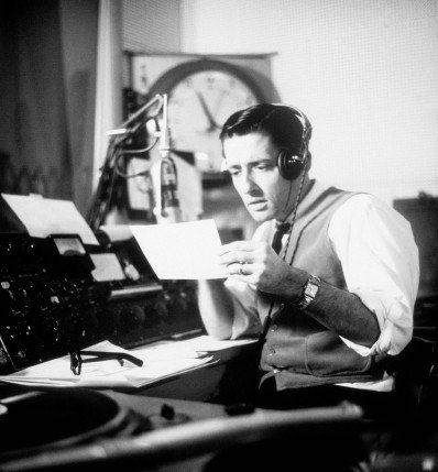 A man recording a podcast in a studio.