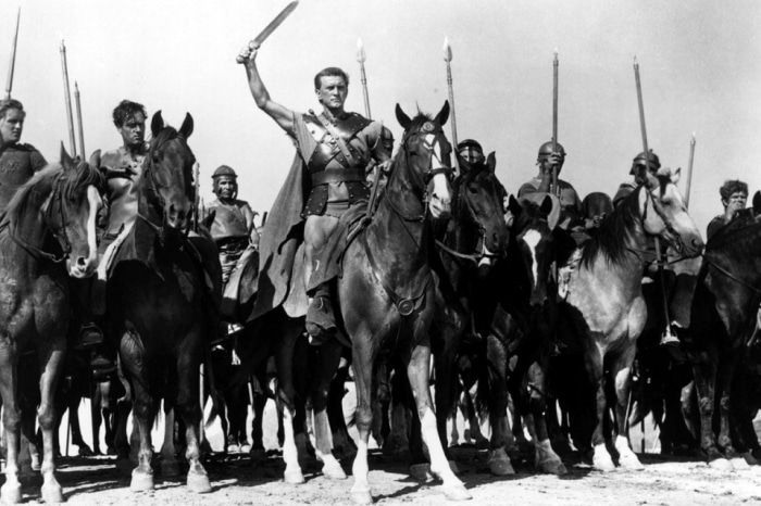 A group of men on horses with swords, resembling Gladiators.