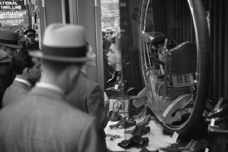 A man in a hat browsing shoes in a store.