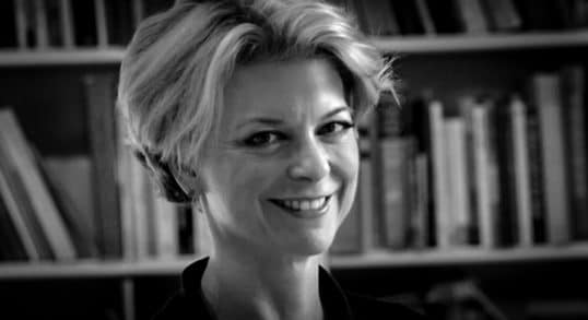 A black and white photo of Frances smiling.