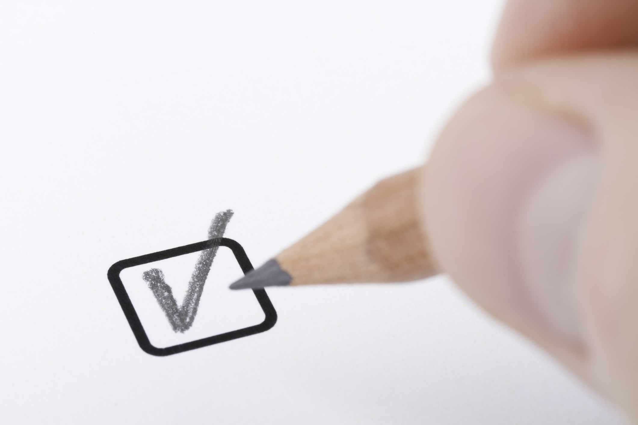 A person is drawing a check mark with a pencil while listening to a Podcast.