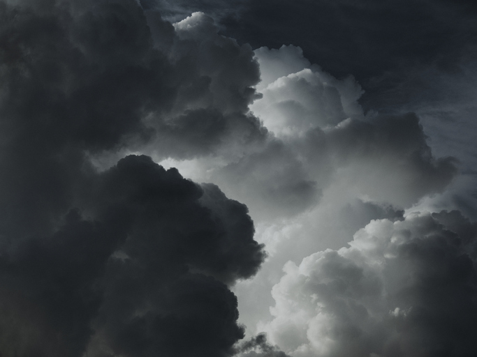 A grayscale image of a cloudy sky.