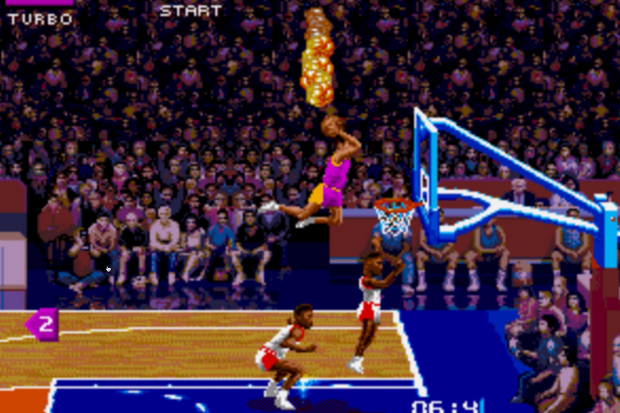 A basketball game with a player jumping in the air.