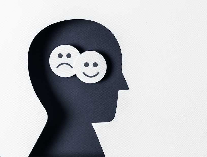 A man's head with two smiley faces, activating his brain.